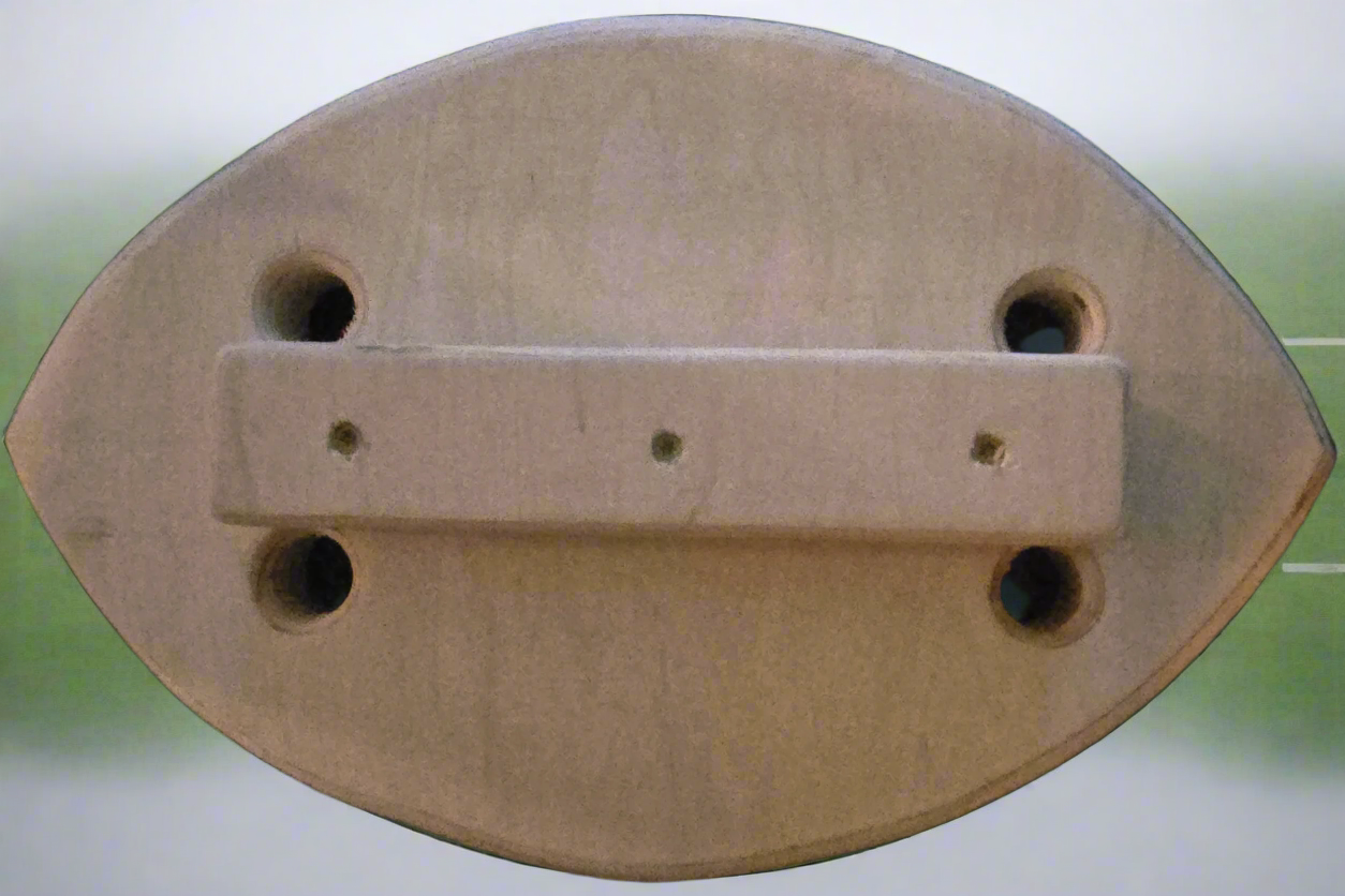 Wooden object with a rectangular bar and circular holes on a blurred background