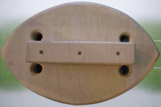 Wooden object with a rectangular bar and circular holes on a blurred background